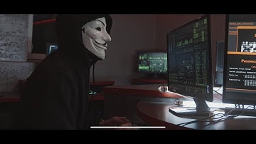 A Person Wearing a Guy Fawkes Mask While Using His Computer