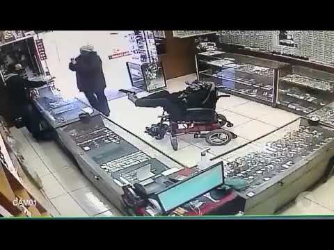 Robbery video: Wheelchair-bound man robbing store in Brazil holding gun with his FEET