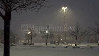 Stock Video - Heavy snow falling in empty parking lot during storm warning