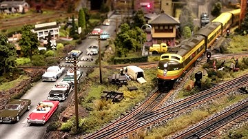 LIONEL AND MTH O GAUGE RUNNING ON SUPER DETAILED LAYOUT.