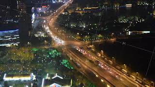 TIME LAPSE: Intersection in Shanghai China at Night with car traffic going by and city lights
