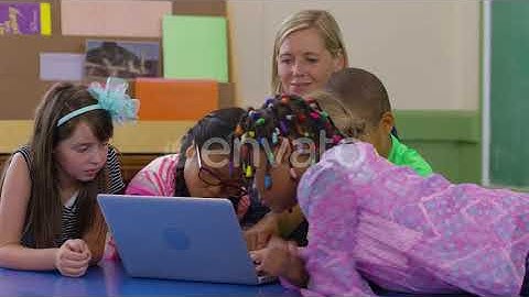 Teacher and group of students use laptop in school classroom | Stock Footage - Envato elements