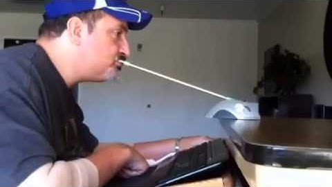Quadriplegic Joe Hall works on computer
