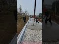 Road Paving Construction Site: Workers Leveling Concrete with Vibrator