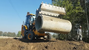 JCB Backhoe Lifting Heavy Culvert Pipe and Installing in Drain - JCB Road Construction video