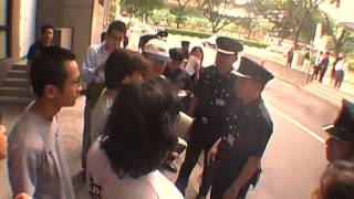 Silent street protesters versus anti-riot police in Singapore