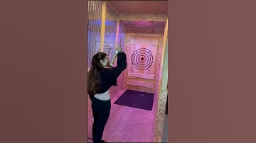 Girl is attempting axe throwing and it doesn