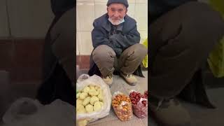 Elderly Uyghur man has to sell fruits on street to survive.