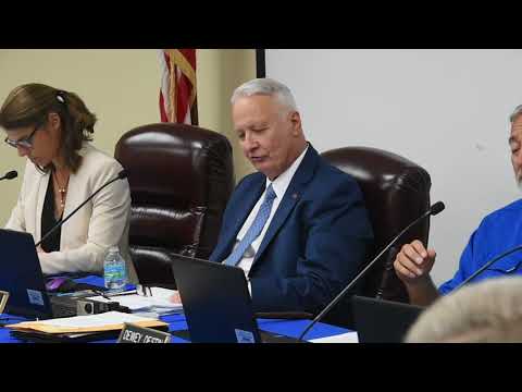 newspaper Okaloosa School Board Chairman Lamar White makes two motions