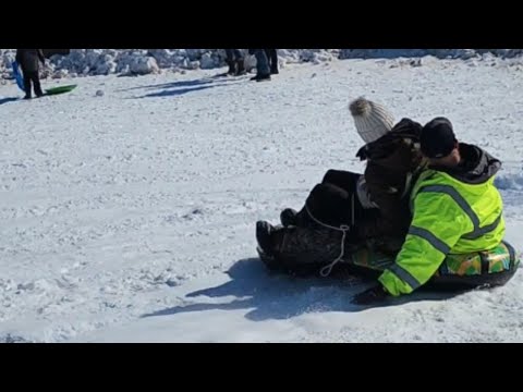Sledding couple sliding