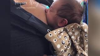 Newborn baby nursing in a KiBi carrier