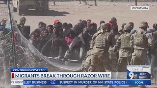Migrants break through razor wire