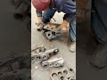 HAMMERING BOLTS TO FLAT SURFACE IN FITTING EXCAVATOR'S TRACK CHAIN LINK AND STEEL BLADES