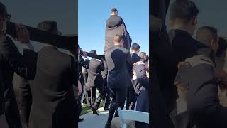 Groom Enters Wedding Ceremony Carried by Groomsmen on Raised Platform
