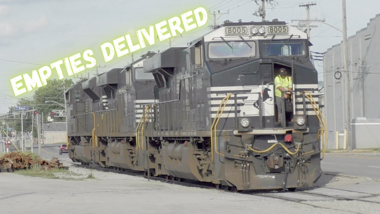 Huge Train pushed grain cars around a very tight curve in the middle of an intersection