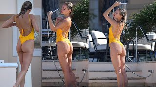Kimberley Garner flaunts her peachy posterior in a plunging yellow swimsuit