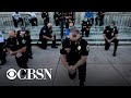 Police officers kneel and march in solidarity with protesters