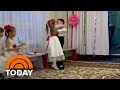 Girl showers boy with kisses after getting special gift