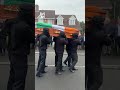 Masked New IRA members carry the coffin of ex-Provo prisoner
