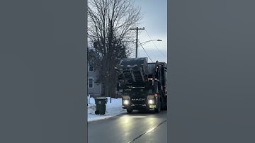 Groot Mack McNeilus, front loader with Curotto can on trash with snow in the morning. ￼