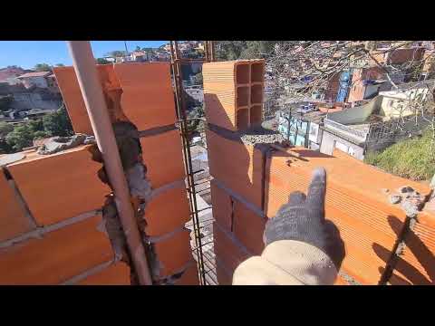 Check out the creativity of this mason locking the wall corner