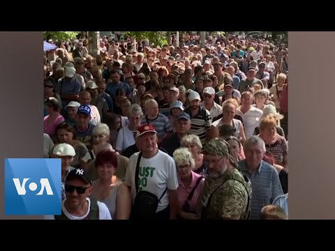 Ukrainians Queue for Water Before Curfew in Mykolaiv.