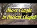 Ghostly hand waves on ghost into doorway in ancient chapel