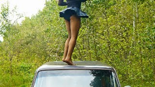 Dancing on the roof of the car in a mini skirt