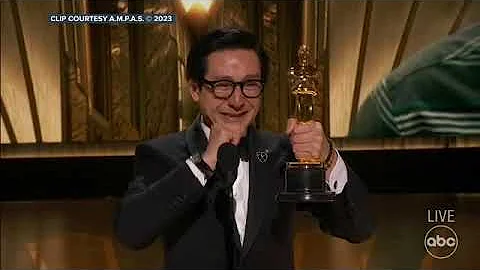 Ke Huy Quan is overcome with emotion as he accepts...