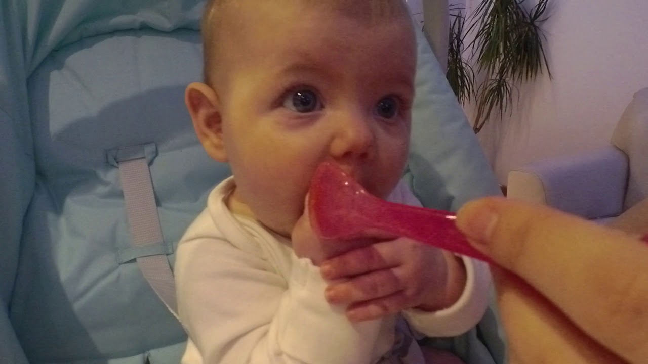 Baby eating solid food for the first time - YouTube