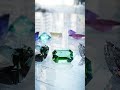 A circular gemstone scene featuring the 12 birthstones, each rendered with a different cut.