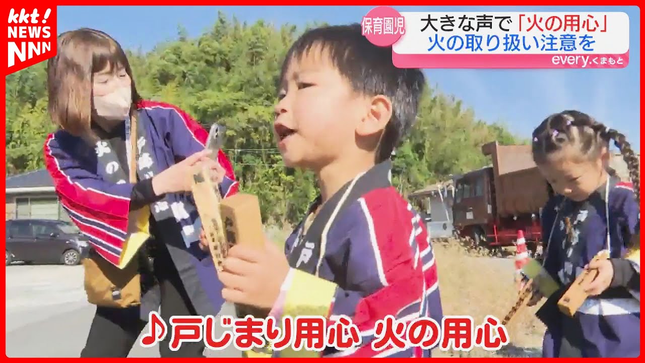 Nursery school children bang on wooden clappers to urge people to 