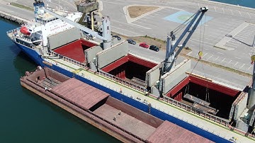 Steel slabs transshipped from vessel to barge, UMEX Terminal