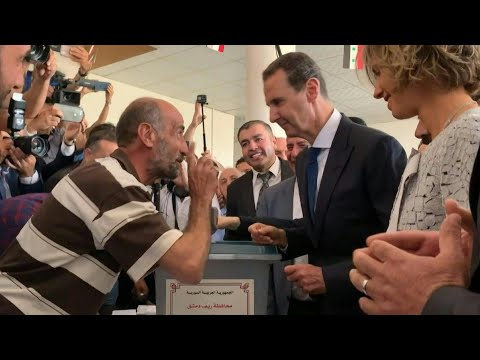 Syrian President Bashar al-Assad and his wife Asma cast their votes in war-torn Douma | AFP