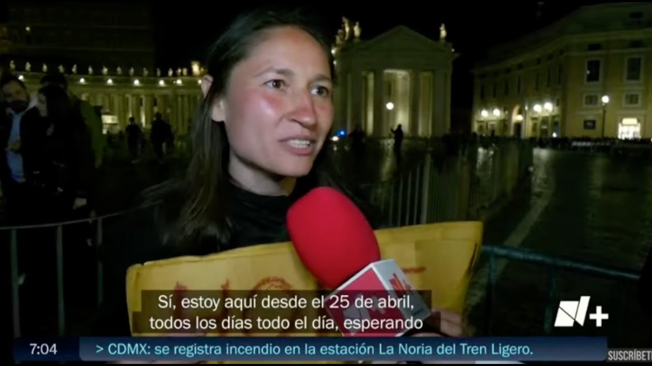 Yona Tukuser holds a "HOPE FOR PEACE" sign in St. Peter's Square at the Vatican during the Conclave