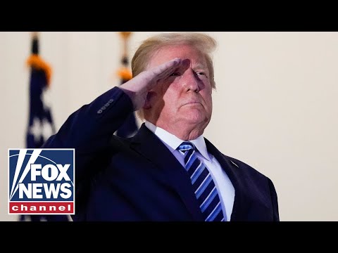 Trump salutes Marine 1 after arriving back at the White House