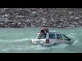 Jeep driver nearly gets washed away by fast moving river