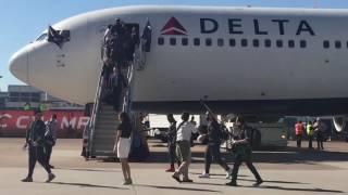 Patriots coach Bill Belichick exits the team plane with girlfriend Linda Holliday