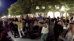 Everyone dances in the street.