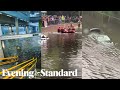 London weather: Streets turn into rivers and Tube station is flooded
