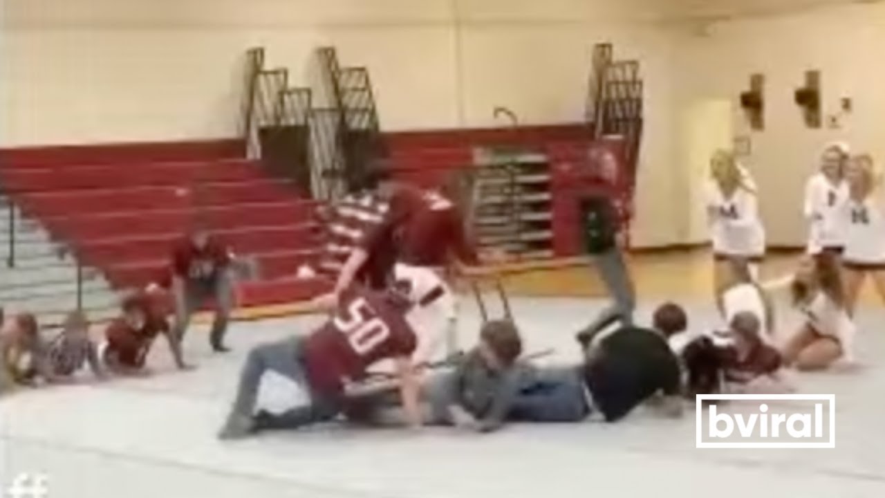 Girl table surfs during a school pep rally! YouTube