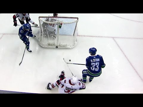 Henrik plays puck to himself behind net, Tanev finds back of net