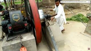 Man in white with vintage machine