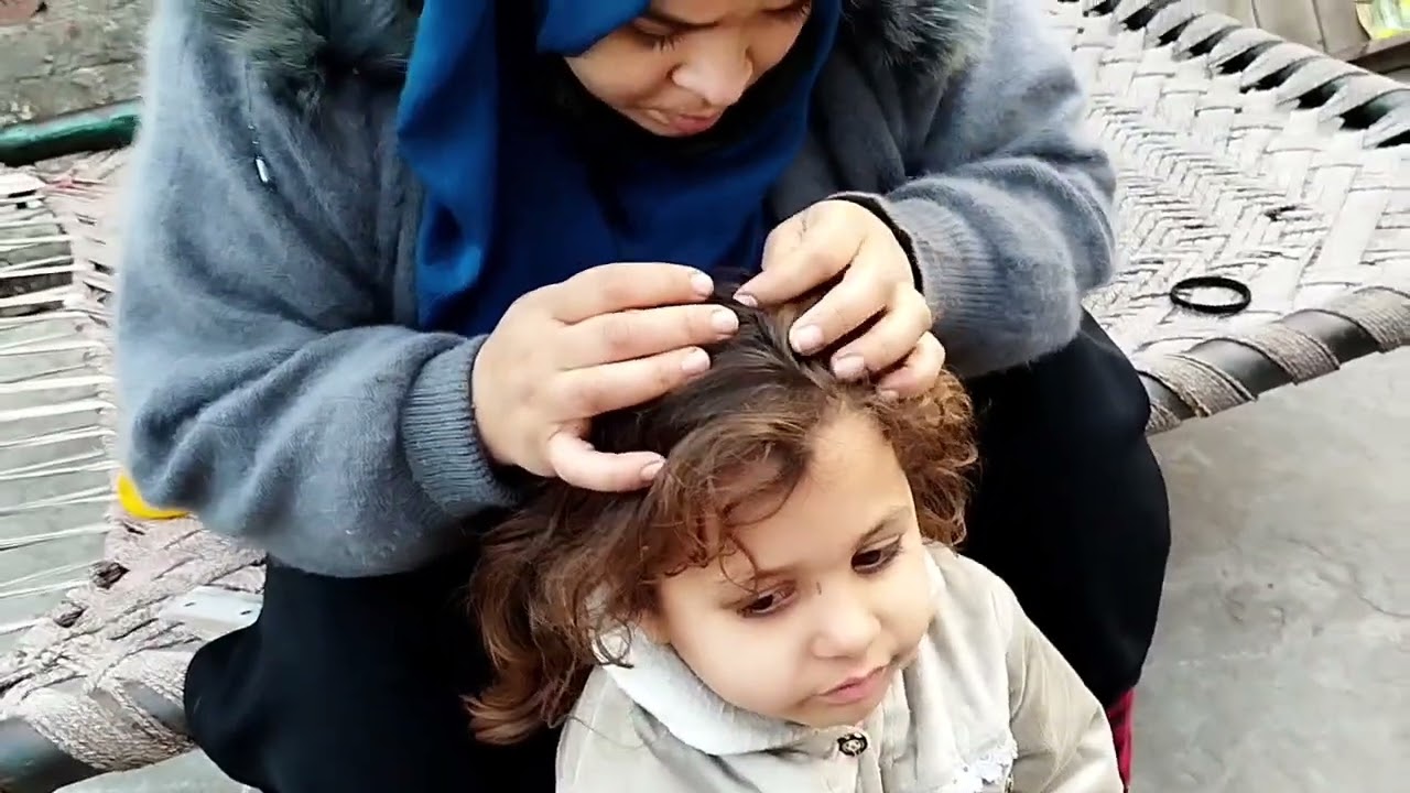 Mom did hair checking of cute little girl