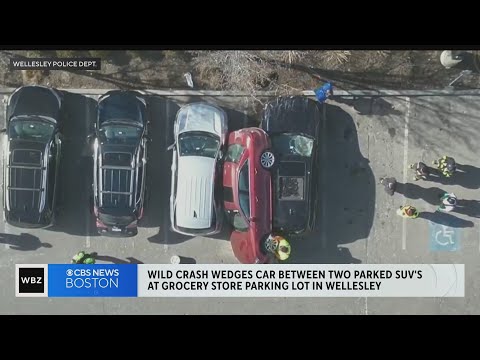 Car crash causes car to get wedged between two parked SUV's at grocery store in Wellesley