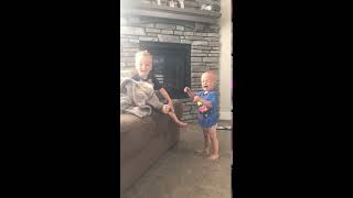 Boy hits little brother on the top of his head