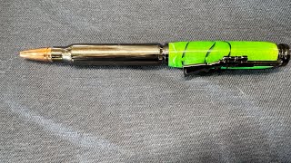 Turning a twist bullet pen from an atomic green acrylic blank.