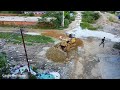Nice job dozer pushing stone to delete the dirt with dump trucks unloading