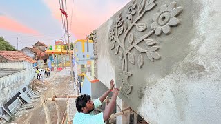 Plastering works with amazing designs on the high front wall of the house using sand and cement