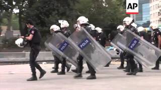 Riot police clash with defiant protesters